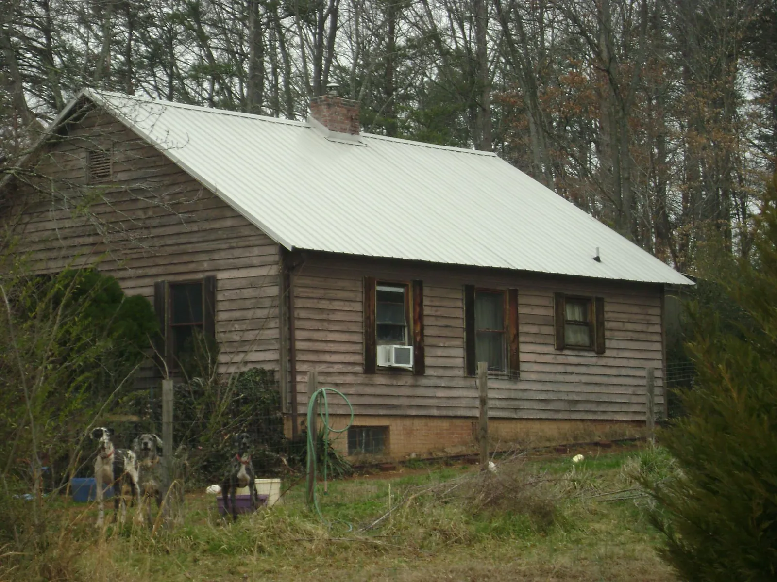 White metal roof on an old wood sided farmhouse, from a Asphalt Shingle Roof Repair job in Charlestown